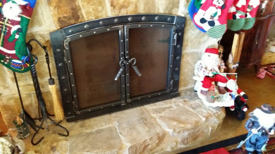 A sturdy arched metal frame with riveted accents and twisted handles,