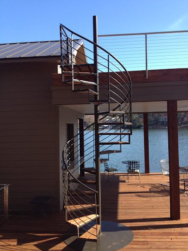 A sleek black metal spiral frame with elegantly curved railings.